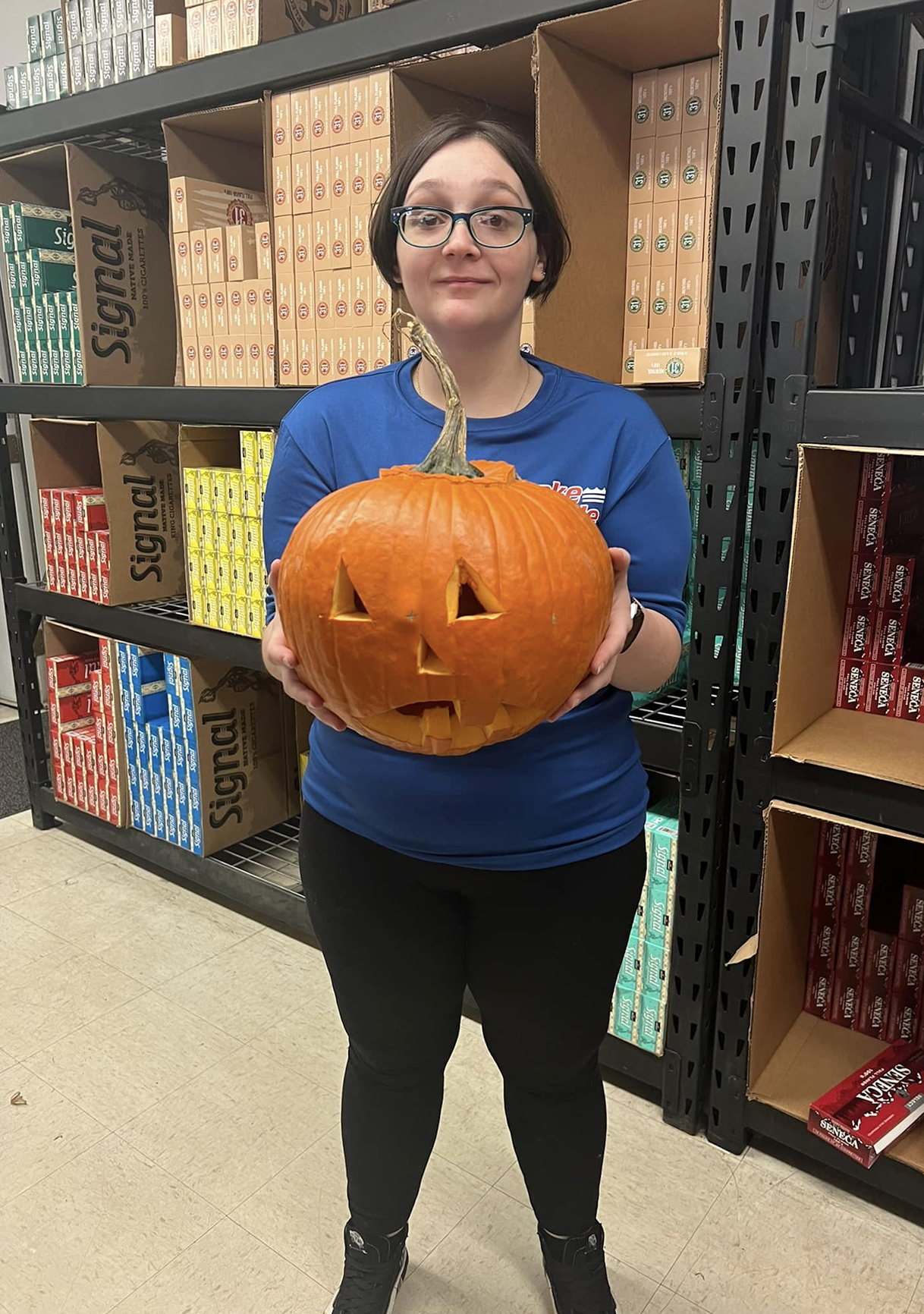 Team member holding a jack-o'-lantern